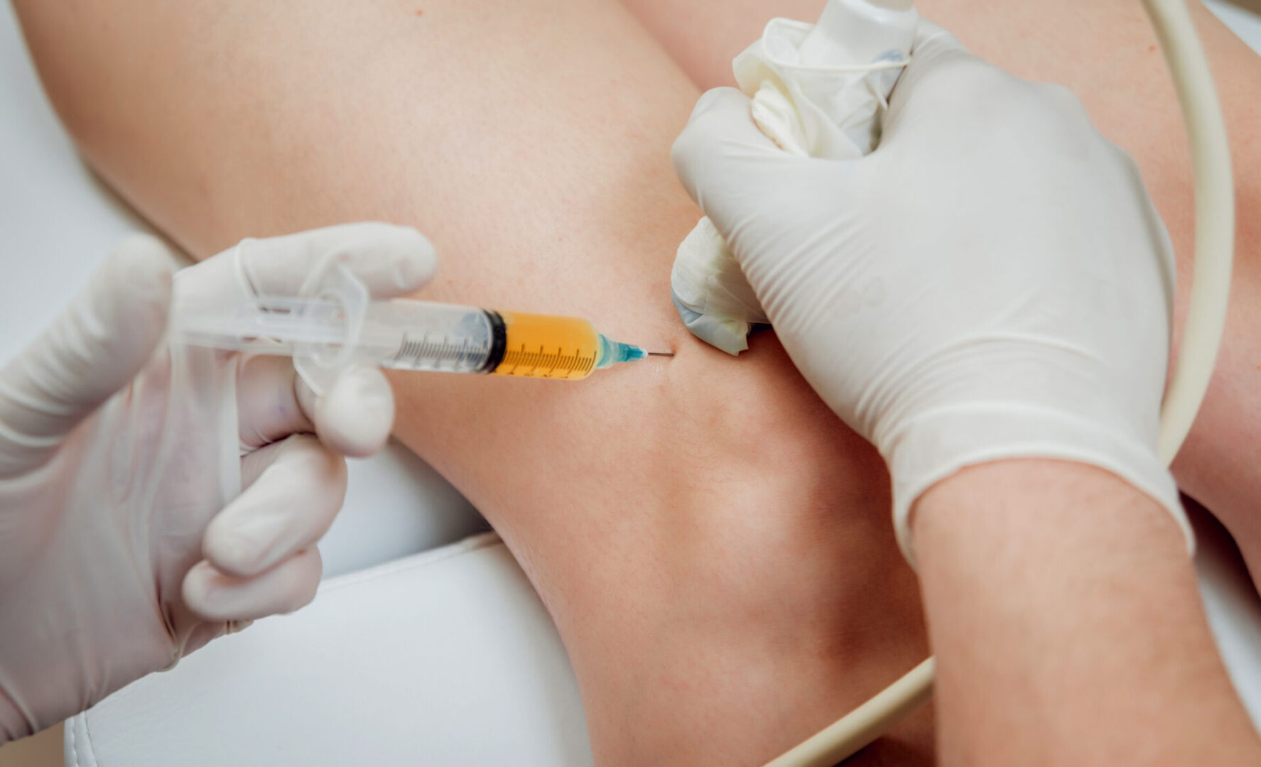 A person getting an injection in their leg.
