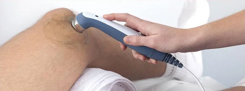 A person is using an electric device to treat the skin.
