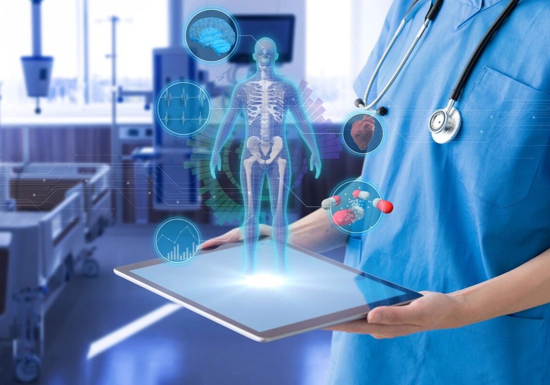 A doctor holding a tablet in his hand.